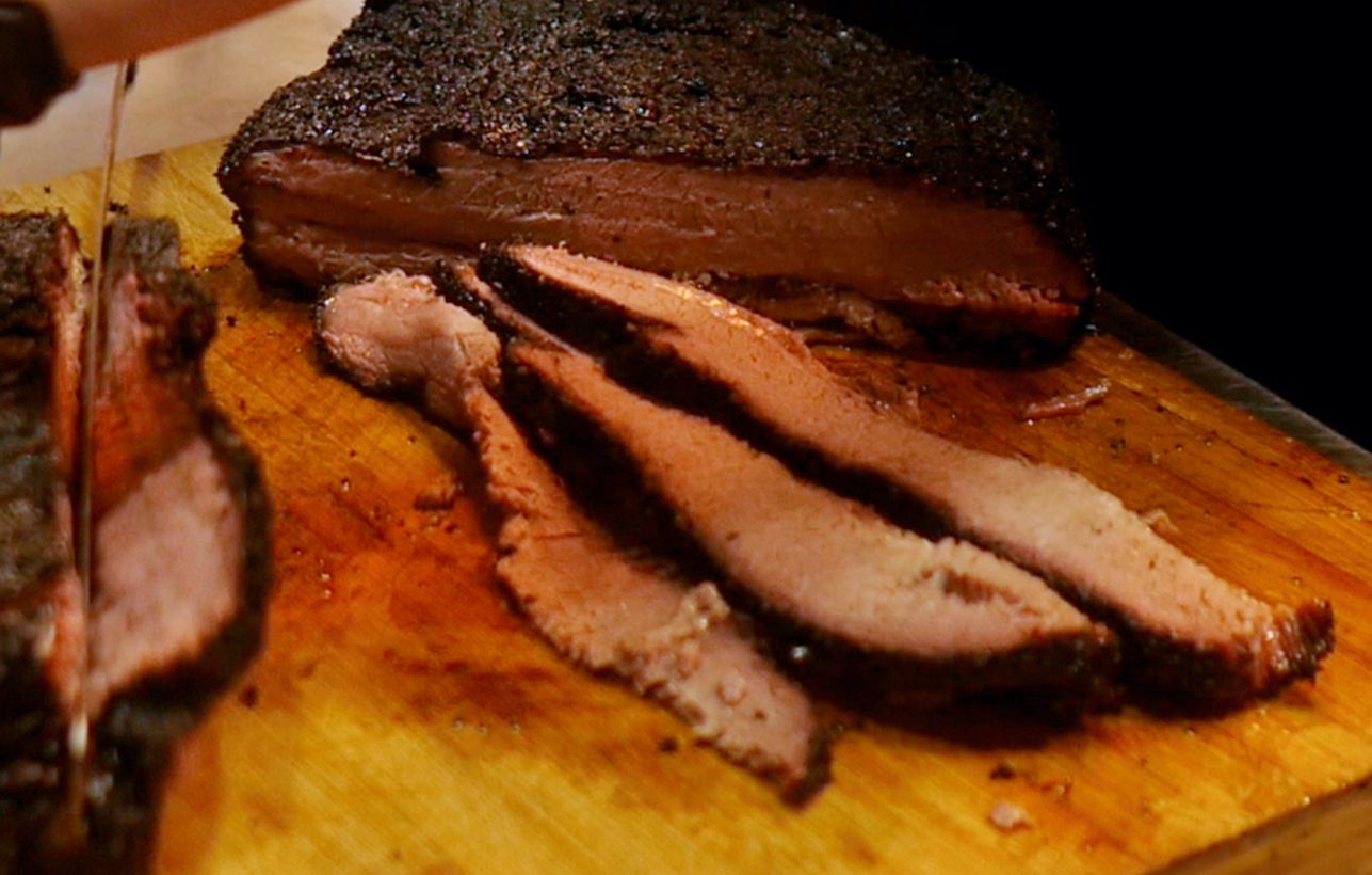 Cooked brisket being sliced